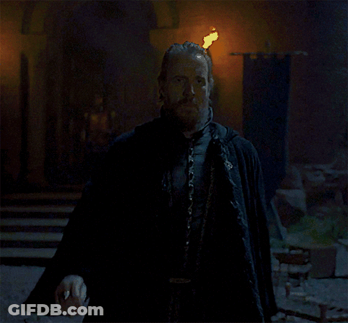 A Man With A Beard And A Cape Stands Next To Another Man GIF