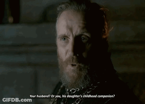 A Man With A Beard And A Chain Around His Neck Is Talking To Another Man . GIF
