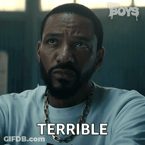 A Man With A Beard And A Chain Around His Neck Says Terrible GIF