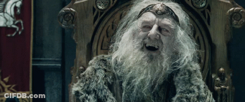 A Man With A Beard And A Crown On His Head Sits On A Throne GIF