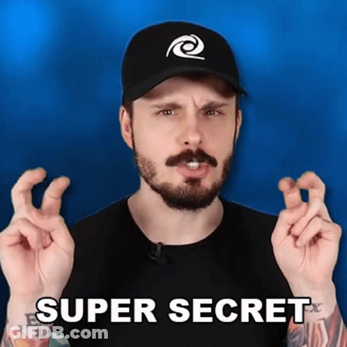 A Man With A Beard And A Hat Is Making A Super Secret Gesture With His Fingers . GIF