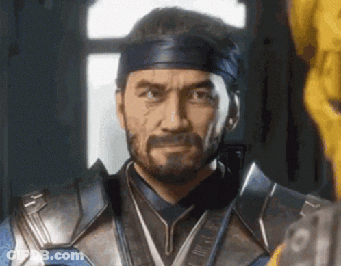 A Man With A Beard And A Headband Is Standing In Front Of A Window In A Room . GIF