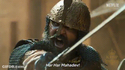 A Man With A Beard And A Helmet Is Holding A Sword And Shouting . GIF
