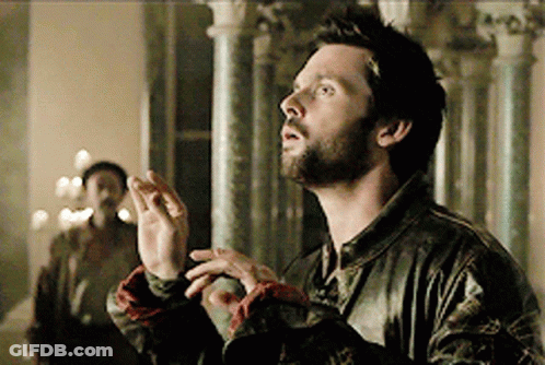 A Man With A Beard And A Leather Jacket Is Looking Up GIF