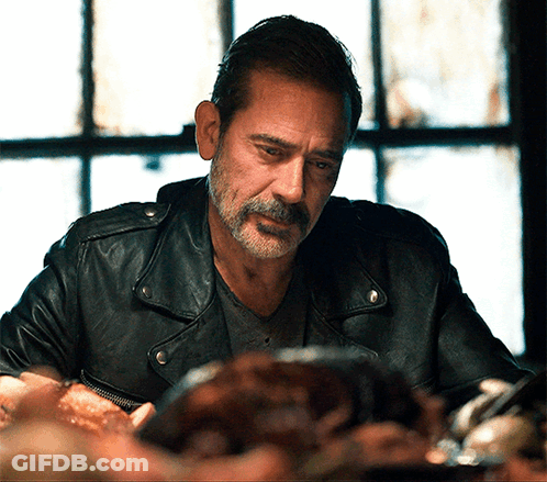 A Man With A Beard And A Leather Jacket Looks At Something GIF