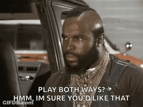 A Man With A Beard And A Mohawk Is Sitting In A Car And Talking . GIF
