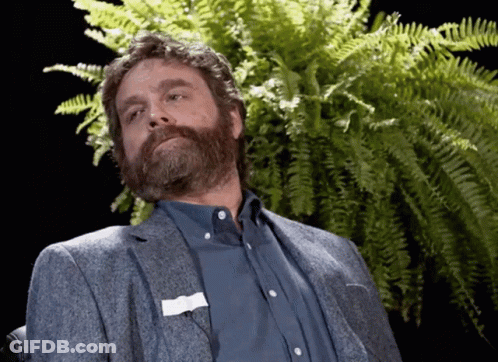 A Man With A Beard And A Name Tag On His Pocket GIF