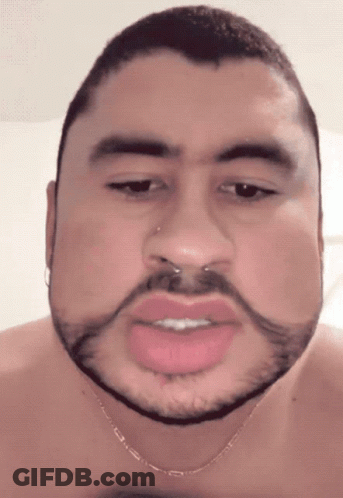 A Man With A Beard And A Nose Ring Is Wearing A Necklace GIF