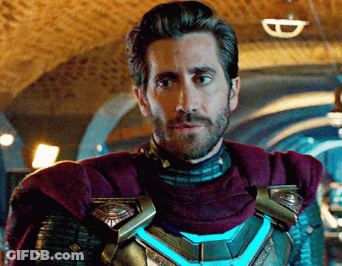 A Man With A Beard And A Purple Cape Is Standing In A Dark Room GIF