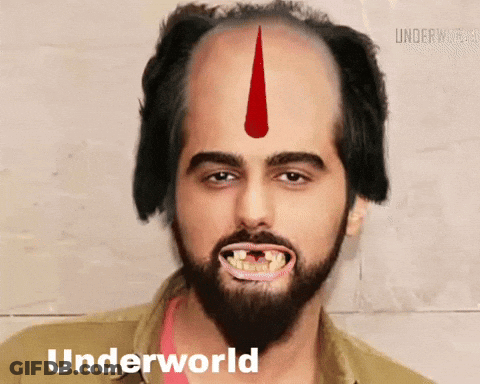 A Man With A Beard And A Red Arrow On His Forehead Has Underworld Written On The Bottom Of His Face GIF