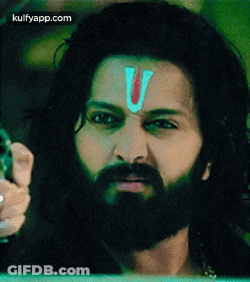 A Man With A Beard And A Red Letter V On His Forehead . GIF