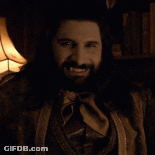 A Man With A Beard And A Ring On His Finger Is Smiling GIF