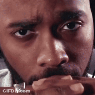A Man With A Beard And A Ring On His Finger Looks At The Camera GIF