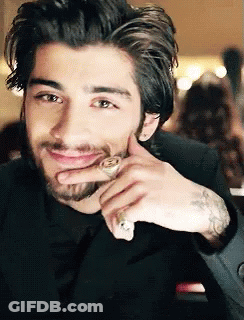 A Man With A Beard And A Ring On His Finger Smiles GIF
