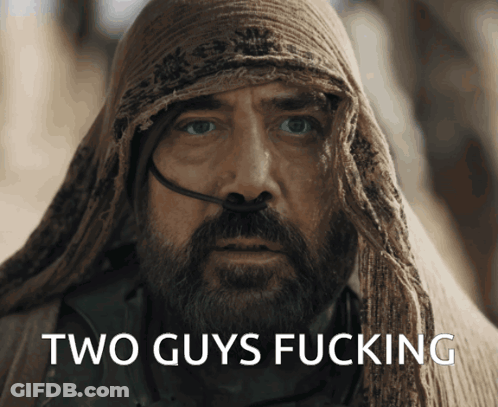 A Man With A Beard And A Scarf Around His Head Has The Words Two Guys Fucking On His Face GIF