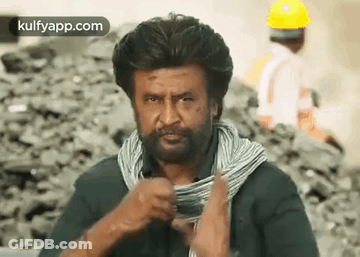 A Man With A Beard And A Scarf Around His Neck Is Holding A Roll Of Wire . GIF