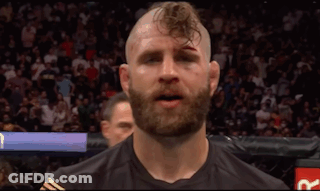 A Man With A Beard And A Shaved Head Has A Black Shirt On GIF