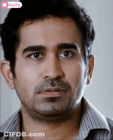 A Man With A Beard And A Striped Shirt Is Looking At The Camera With A Surprised Look On His Face . GIF