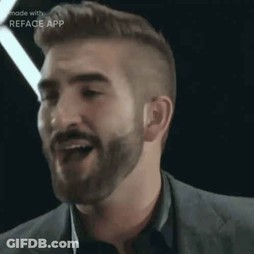 A Man With A Beard And A Suit Is Made With Reface App GIF
