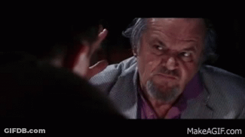 A Man With A Beard And A Suit Is Talking To Another Man . GIF