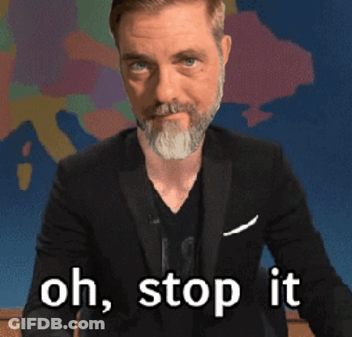 A Man With A Beard And A Suit Says Oh Stop It GIF
