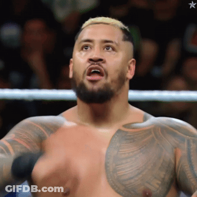 A Man With A Beard And A Tattoo On His Chest Is Standing In A Boxing Ring GIF