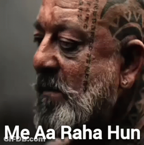 A Man With A Beard And A Tattoo On His Face . GIF