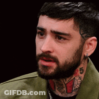 A Man With A Beard And A Tattoo On His Neck Has The Number 5 On It GIF