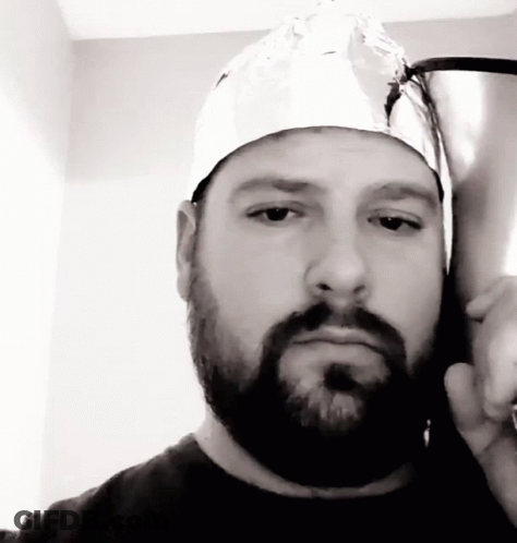 A Man With A Beard And A Tin Foil Hat On His Head GIF