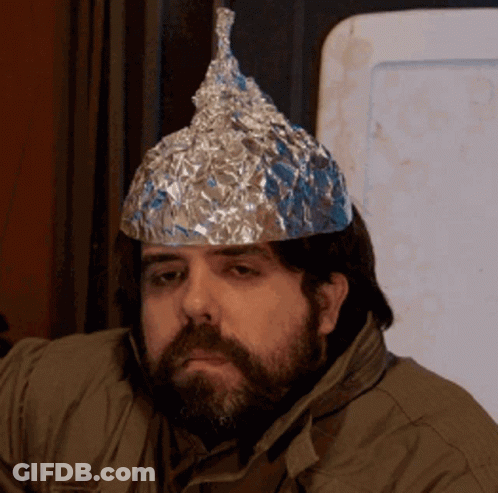 A Man With A Beard And A Tin Foil Hat On His Head GIF