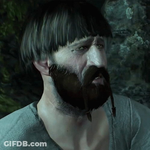 A Man With A Beard And A Very Short Haircut Has A Necklace Around His Neck GIF