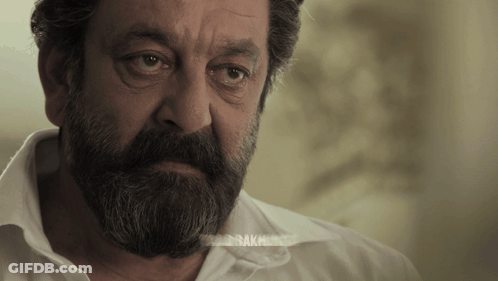 A Man With A Beard And A White Shirt Has The Word " Bak " On His Shirt GIF