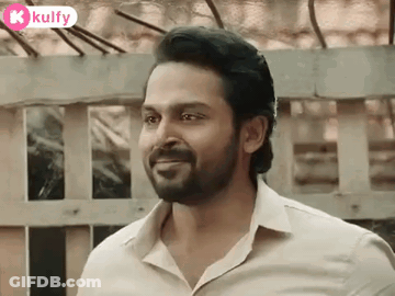 A Man With A Beard And A White Shirt Is Smiling . GIF