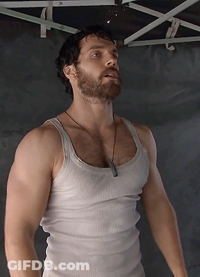 A Man With A Beard And A White Tank Top GIF