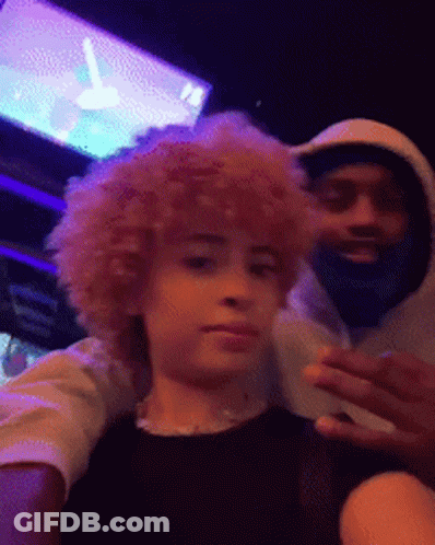 A Man With A Beard And A Woman With Curly Hair Are Posing For A Picture Together . GIF
