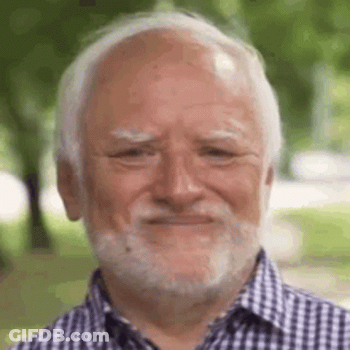 A Man With A Beard And Bald Head Is Smiling . GIF
