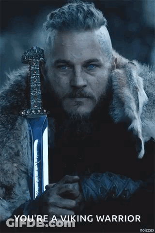 A Man With A Beard And Blue Eyes Is Holding A Sword And Says `` You 'Re A Viking Warrior '' . GIF