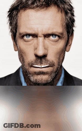 A Man With A Beard And Blue Eyes Is Looking At The Camera GIF