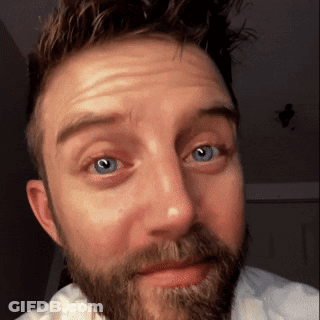 A Man With A Beard And Blue Eyes Is Making A Face GIF
