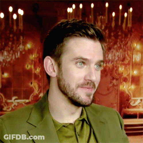 A Man With A Beard And Blue Eyes Is Wearing A Green Jacket GIF