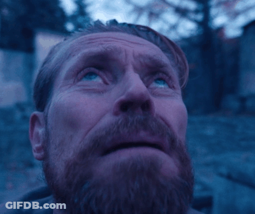 A Man With A Beard And Blue Eyes Looks Up At The Sky GIF
