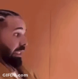 A Man With A Beard And Braids Is Wearing Earrings And A Jacket . GIF