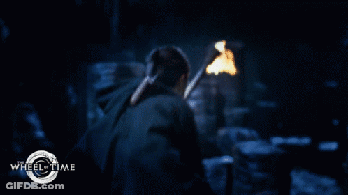 A Man With A Beard And Curly Hair Is In A Wheel Of Time Poster GIF
