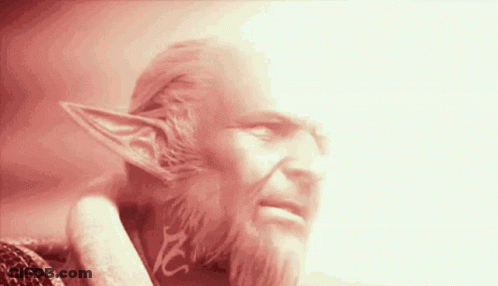 A Man With A Beard And Elf Ears Has A Red Light Behind Him GIF