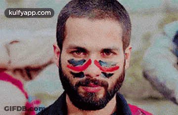 A Man With A Beard And Face Paint On It . GIF
