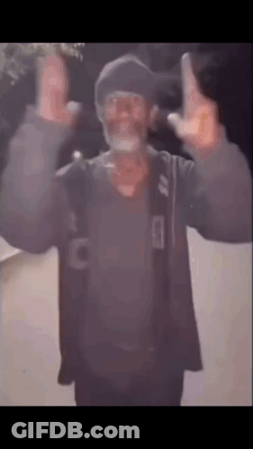 A Man With A Beard And Glasses Is Giving The Middle Finger While Wearing A Hat . GIF
