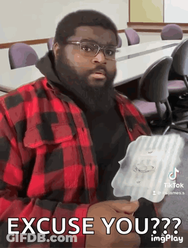A Man With A Beard And Glasses Is Holding A Piece Of Paper That Says Excuse You ? GIF