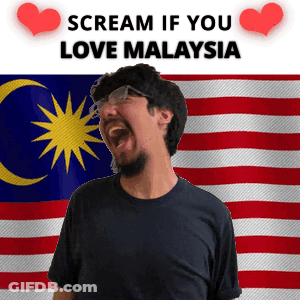A Man With A Beard And Glasses Is Screaming In Front Of A Malaysian Flag GIF