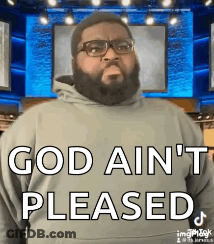 A Man With A Beard And Glasses Is Standing In Front Of A Blue Screen And Says God Ain 'T Pleased GIF