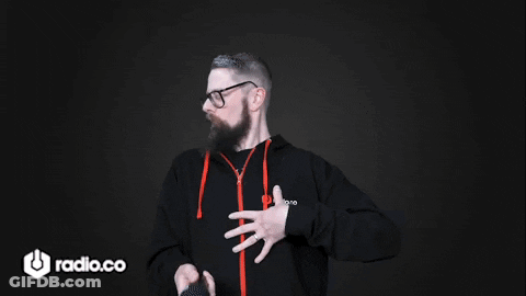 A Man With A Beard And Glasses Is Wearing A Black Hoodie With The Word Radio.co On It GIF